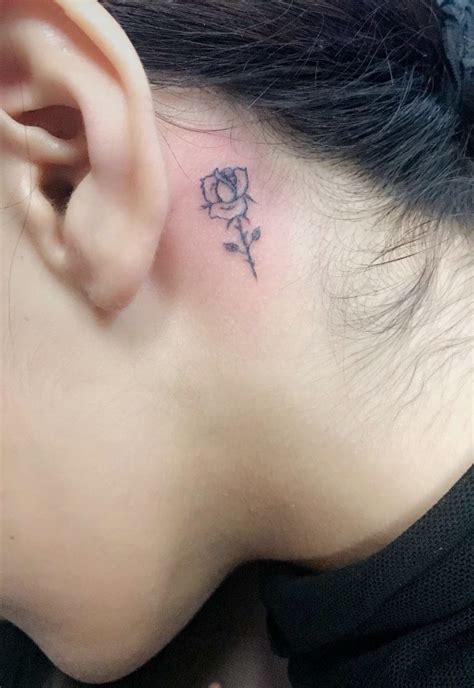 It's sweet and actually puts a smile on our faces. Tiny black rose tattoo behind the ear - Tattoogrid.net