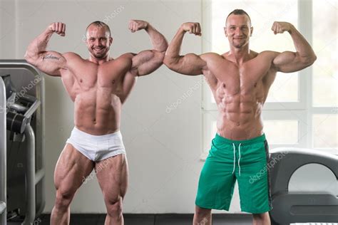 Find the best weight lifting exercises that target each muscle or groups of my name is alex, and i'm the owner and author of king of the gym. Two Muscular Men Flexing Muscles In Gym — Stock Photo ...