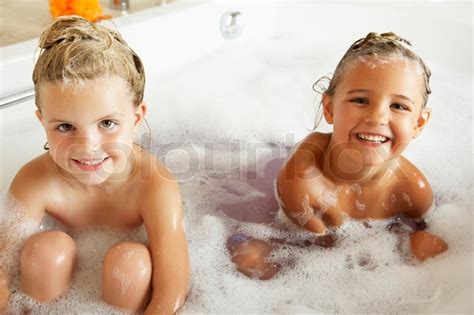 4k00:18cheerful boy and his two fathers enjoying home activity, riding on dads back and spinning around. Two Girls Playing In Bath Together | Stock Photo | Colourbox