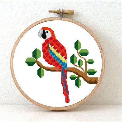 These cross stitch patterns can be easily crafted into christmas ornaments by mounting into 3 embroidery hoops. Parrot cross stitch kit | Modern tropical bird cross ...