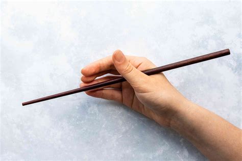 ①hold one of the chopstick tightly between your thumb and index finger, and stabilize it. How to Use Chopsticks