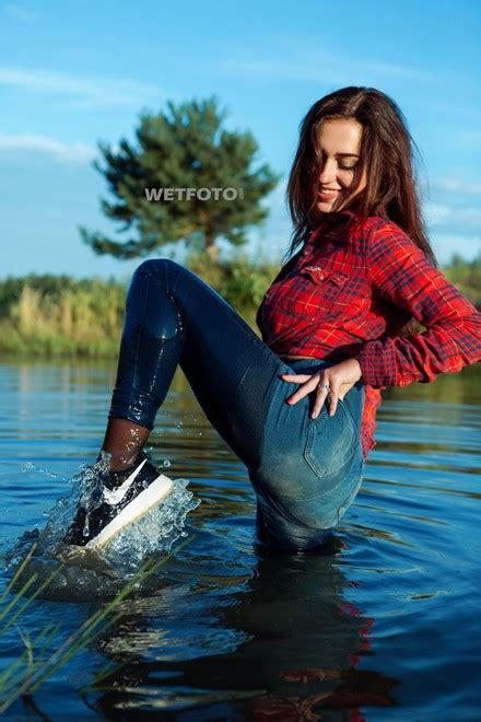 Slouchy overalls from denim fave levi's featuring crisscross straps in back and a front bib pocket. Wetlook by Brunette Girl in Soaking Wet Jeans, Shirt and Sneakers - Wetlook.one