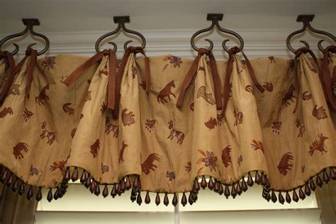 Fake high ceilings by hanging your curtains as high as possible. Love the hooks hanging from the ceiling on this valance ...