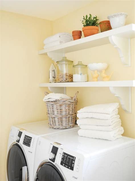 Gray floating laundry room shelves with sage green paint color and wicker laundry room baskets. 40 Paint Color Ideas for Every Room | HGTV in 2020 | Laundry room paint color, Yellow bedroom ...