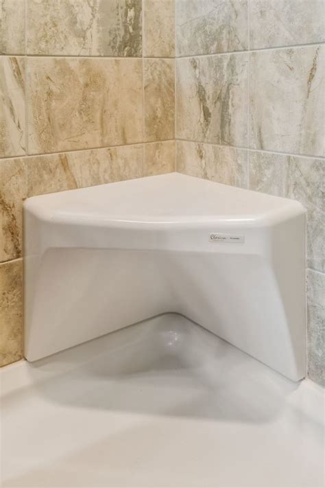 If you plan to have a solid wall as part of your walk in shower, use a neutral tile color that maintains the airiness of the bathroom. Ceramic Tile Shower Corner Seat | Commodore of Pennsylvania