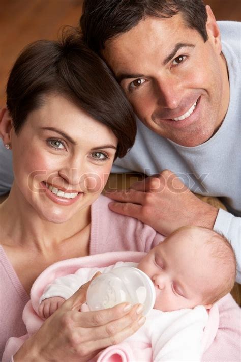 Here you may to know how to adopt a newborn baby quickly. Portrait Of Parents Feeding Newborn ... | Stock Photo ...